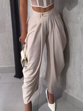 Beige high-waisted wide leg pleated pants with tailored fit and subtle side seam detailing for a polished look