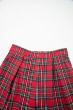 Red plaid wide-leg pants with green and white stripes featuring a pleated skirt design