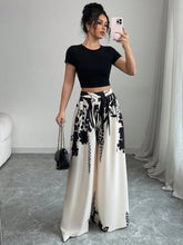 Black and white floral print high-waisted wide leg pants made from lightweight fabric for stylish comfort
