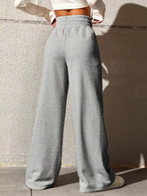 Gray wide leg drawstring waist pants made of soft comfortable fabric with elastic waistband for relaxed wear
