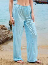 Light blue sequin wide leg pants with drawstring waist featuring shimmering sequined fabric and a relaxed fit