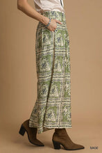 Sage green umgee bohemian print wide-leg pants with intricate white and black paisley patterns and pockets