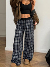 Black and white plaid pants with a relaxed fit and drawstring waistband perfect for comfortable casual wear