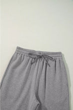 Gray heathered drawstring loose fit pants with elastic waistband and matching drawstring for comfortable wear