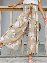 Beige floral wide leg pants with pink and white blossoms and a tied waist waistband for a stylish look