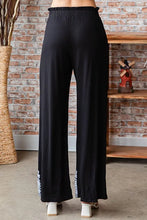 Heimish full size solid damask casual pants in black with high-waisted elastic and white patterned trim on cuffs