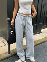 Light gray wide leg drawstring sweatpants with loose fit and drawstring waistband suitable for casual wear and care instructions