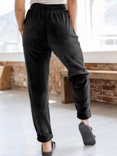 Black relaxed fit corduroy pants with rolled cuffs made from soft corduroy fabric for comfortable wear