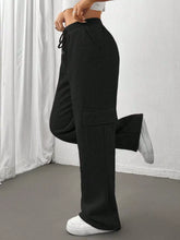Black relaxed fit cargo pants with drawstring waist and large side pockets for comfortable casual wear