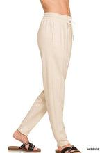 Beige zenana drawstring scuba sweatpants with relaxed fit and side pockets made from soft scuba fabric