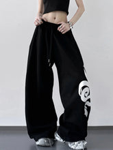 Black wide leg drawstring pants featuring bold white graphic on the side for comfortable casual wear