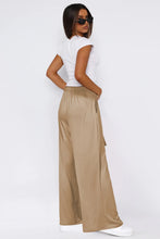 Beige satin tied pocketed wide leg pants with high-waisted elastic waistband and side pockets for stylish comfort