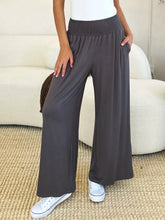 Dark gray wide-leg pants from basic bae featuring a smocked wide waistband with side pockets and stretchy material