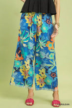 Blue umgee floral print wide leg pants with frayed hems featuring a blue floral print wide leg design