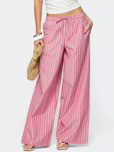 Pink and white striped wide leg pants with a drawstring waistband in lightweight fabric for casual wear