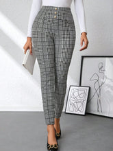High waist plaid slim fit pants featuring high-waisted black and white houndstooth leggings with button waist detail