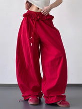Vibrant red wide leg pants with ruffled waistband and drawstring detail for stylish comfortable wear