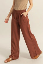 Brown hyfve wide-leg pants with elastic waistband and side pockets offering comfortable casual wear and easy care instructions