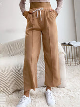 Tan wide leg drawstring casual pants with side pockets designed for comfortable everyday wear