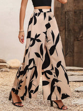 Beige printed wide leg pants featuring bold black leaf patterns for stylish and comfortable wear
