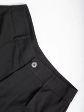 Black high-waisted wide-leg pants with subtle woven texture and silver-toned button at the waistband