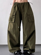 Olive green drawstring wide leg cargo pants with large flap pockets designed for casual and utility wear