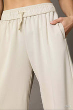 Beige umgee wide leg pants with elastic drawstring waistband and subtle vertical pleats for a relaxed fit