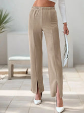 Beige corduroy high-waisted slit pants with wide-leg design and elastic waistband featuring side slit detailing