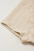 Cream-colored textured shorts with woven pattern and elastic waistband