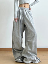 Gray heathered drawstring wide leg pants with elastic waistband and wide loose fit featuring care instructions