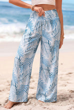 Light blue and white tropical print shirred waistband wide leg pants with a tropical print pattern