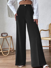 Black high waist wide leg trousers with gold button closure offering a stylish and elegant fitted look