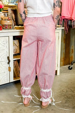 Pink and white vertically striped cotton wide leg pants with stripe contrast lace trim and ribbon tie detail at ankles