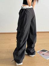 Black bow elastic waist cargo pants with lightweight fabric, multiple side pockets, and a drawstring elastic waist design