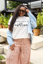 White graphic tee with wildflower text under basic style denim jacket