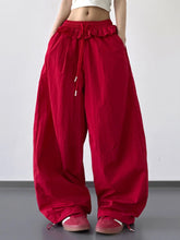 Red ruffled wide leg pants with a loose fit and drawstring waist ideal for casual wear