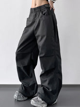Black wide leg cargo pants with sleek modern design and subtle reflective sheen perfect for urban wear
