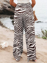 Plus size zebra print high waist wide leg pants in bold black and white stripes for stylish comfort