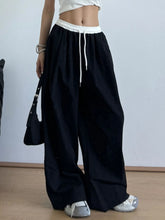 Black wide leg drawstring casual pants with white elastic waistband and drawstring for comfortable wear