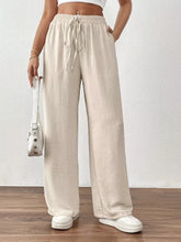 Beige casual drawstring wide leg pants with elastic waistband made of textured fabric for comfortable wear