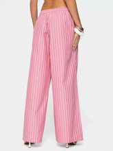 Pink and white striped wide leg pants featuring vertical stripes and a relaxed fit for stylish comfort