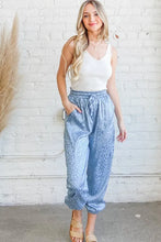 Light blue satin leopard print joggers with elastic waistband and cuffed ankles machine wash cold