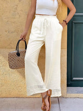Cream-colored wide leg pants with drawstring waist and crochet trim offer a perfect fit and stylish wide-leg pants design