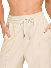 Cream-colored relaxed-fit zenana drawstring scuba sweatpants with side pockets and a drawstring waistband