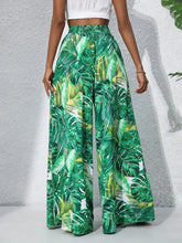 Printed high waist wide leg pants featuring green tropical leaf print for stylish summer wear