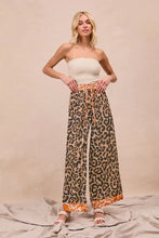 Leopard print wide-leg pants with orange drawstring waistband and floral hem from bibi leopard print collection