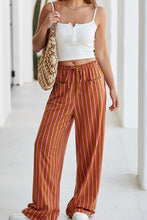 Wide leg stripe button pocket tie waist casual pants with vertical orange and pink stripes in lightweight fabric
