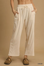 Cream-colored corduroy umgee drawstring wide leg pants with side pockets for comfortable casual wear