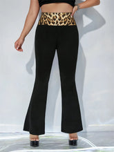 Black high waist flare pants featuring a bold gold leopard high waist waistband for stylish waist flare pants look
