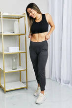Black high-waisted cropped joggers with wide waistband and side pockets from leggings depot with tapered leg cut